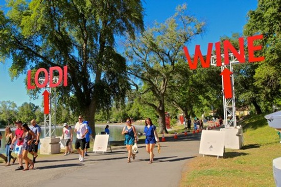 Visitors walking towards wine tasting area at Lodi Winegrape Commission event.