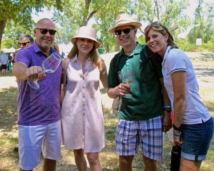 Group of people enjoying wine tasting outdoors at a Lodi wine event.