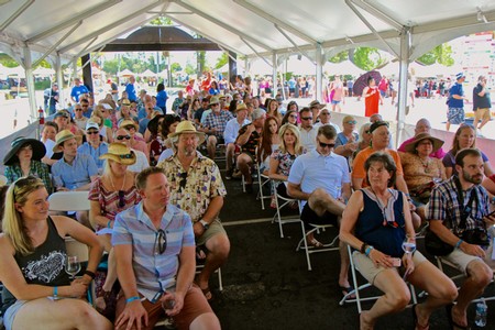 Crowd of people attending a Lodi Winegrape Commission event under a large tent.
