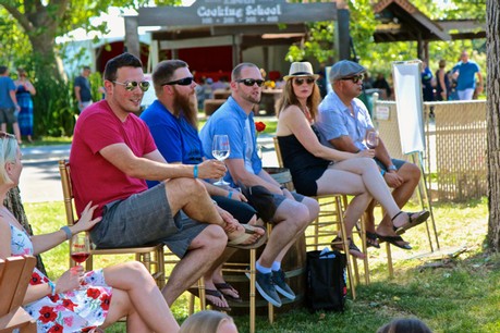 Group of people enjoying a wine tasting event outdoors at Lodi Winegrape Commission.