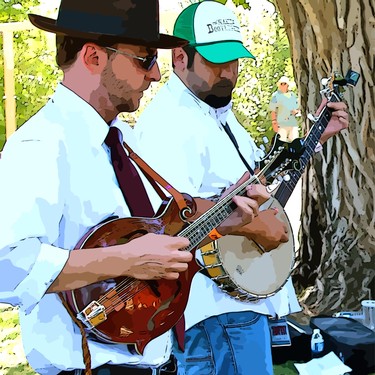 Two musicians playing banjos outdoors at a Lodi Winegrape Commission event.