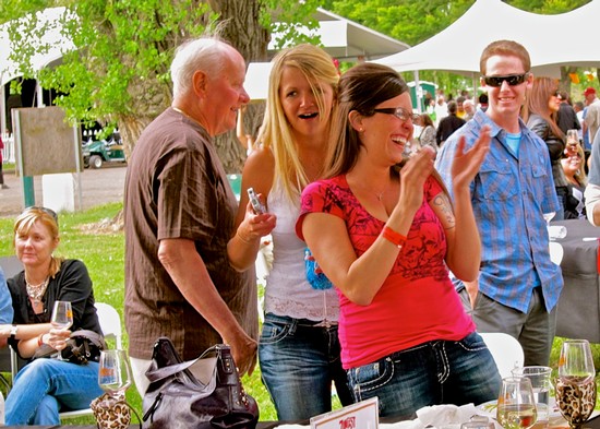 Group of people enjoying wine tasting at an outdoor event in Lodi, California.