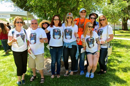 Group of people at Lodi Winegrape Commission event enjoying wine and outdoor activities.