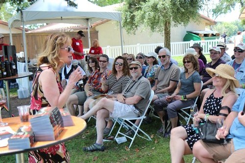 Group of people attending an outdoor wine tasting event organized by the Lodi Winegrape Commission.