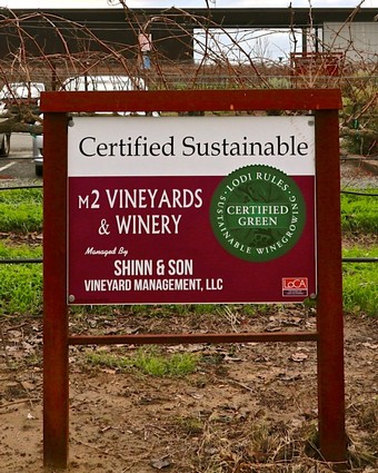 Vineyard sign indicating certified sustainable and green practices at M2 Vineyards & Winery in Lodi.