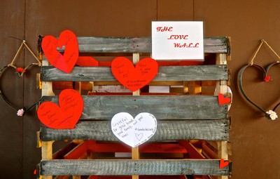 Decorative wooden pallet with red and white hearts and love notes for Valentine's Day.