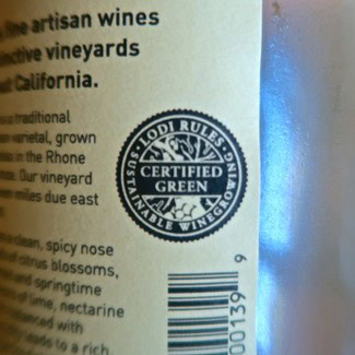 Lodi Winegrape Commission certified green seal on wine bottle label for sustainable practices.
