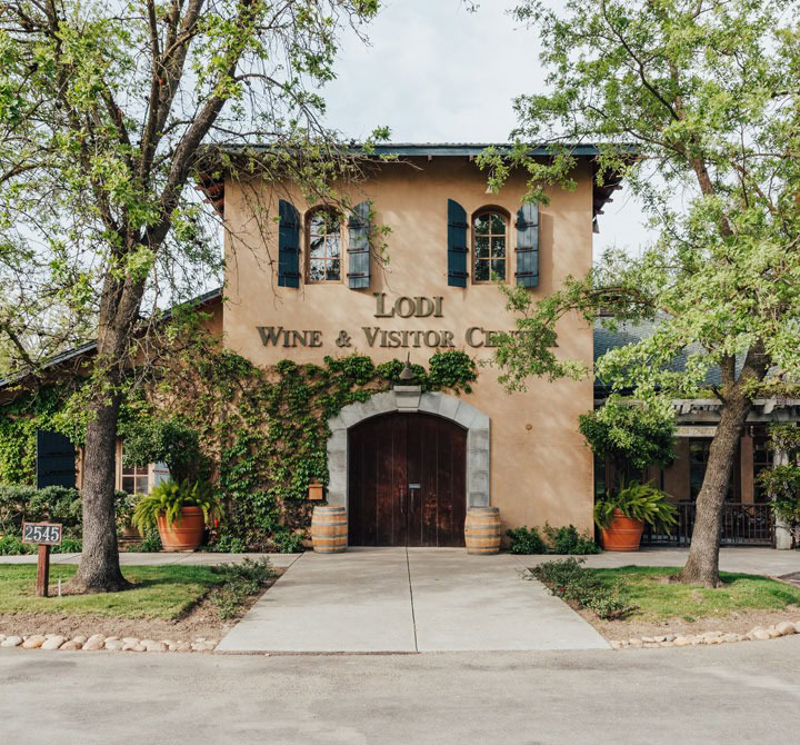 Lodi Wine & Visitor Center building with vines and trees in Lodi, California.