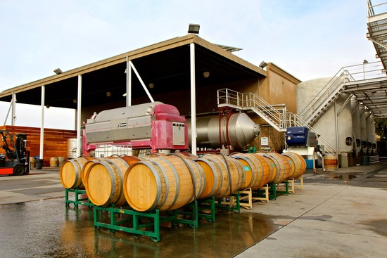 Lodi Winegrape Commission facility with wine barrels and industrial equipment in California.